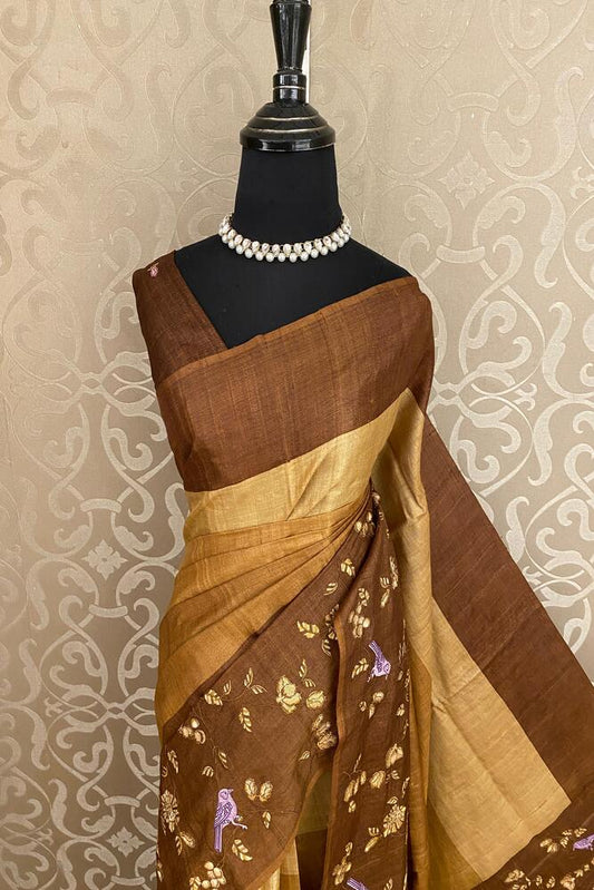 Brownish yellow Tussar Resham embroidery saree with unstitched blouse, traditional wear by Saarang Sarees.