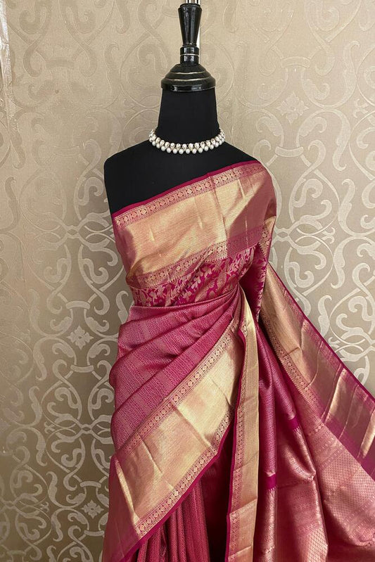 Magenta pure Kanjeevaram silk saree with intricate gold zari work and unstiched blouse, traditional wear by Saarang Sarees.