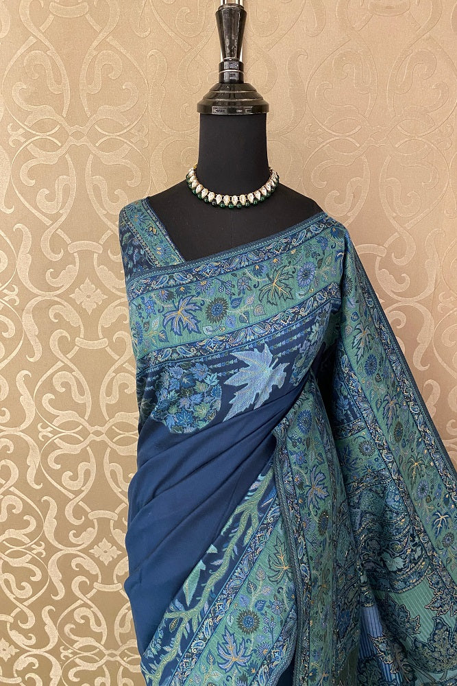 Navy blue pure Kani handloom silk saree with floral woven blouse, traditional wear by Saarang Sarees, unstitched blouse visible.