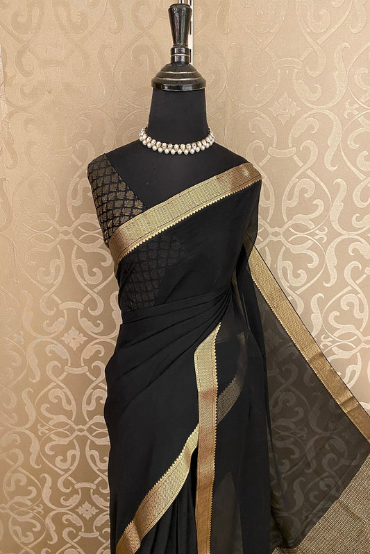Black chiffon saree with zari border and unstiched blouse, perfect for party wear by Saarang Sarees.