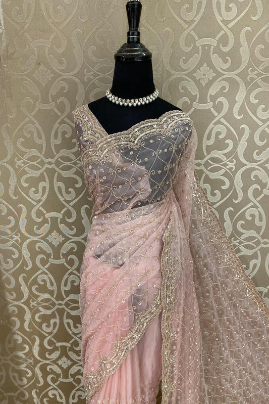 Baby pink organza silk party wear saree with intricate embroidery and unstiched blouse from Saarang Sarees, perfect for special occasions.