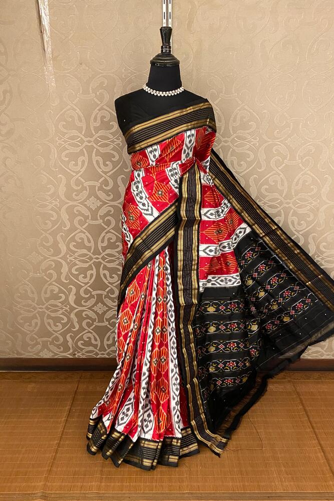 Red and multi-color Pochampally Ikat silk saree with intricate patterns, paired with an unstiched blouse, traditional wear by Saarang Sarees.