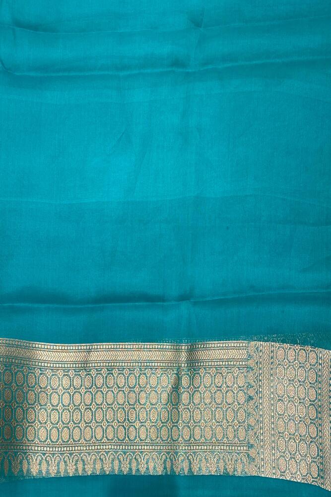 Teal blue Kora Banarasi silk saree with intricate handwoven work and matching unstiched blouse, traditional wear by Saarang Sarees