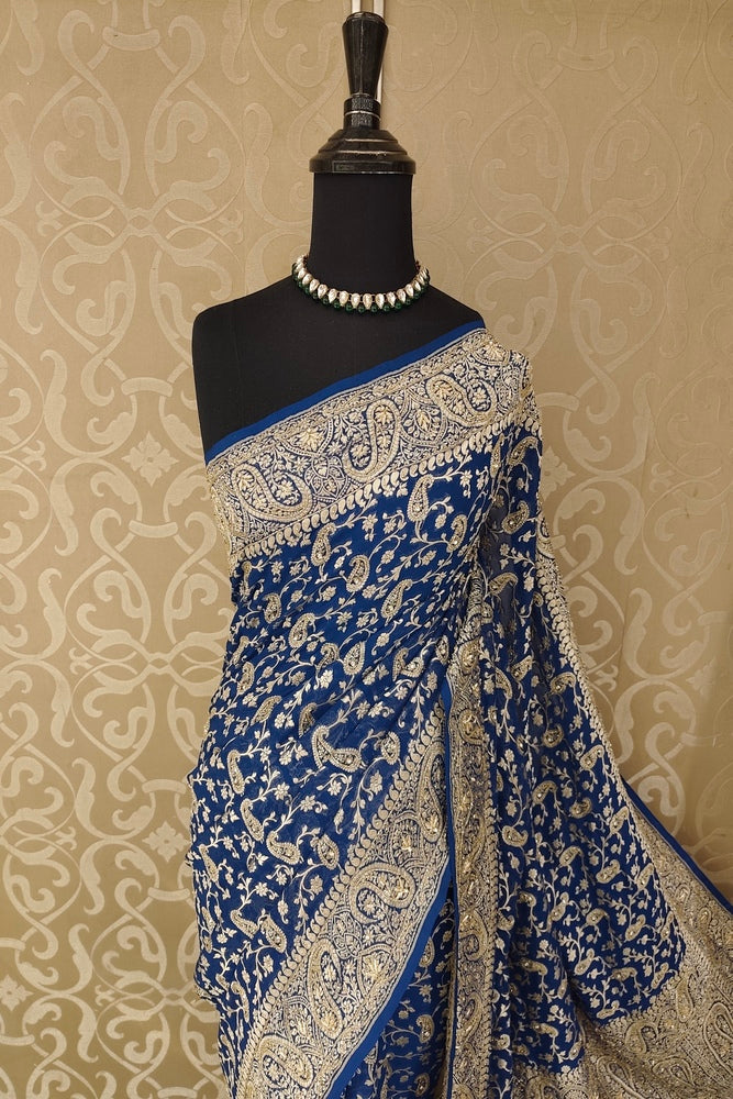 Deep blue crepe georgette saree with intricate embroidery and matching unstiched blouse, traditional wear by Saarang Sarees.