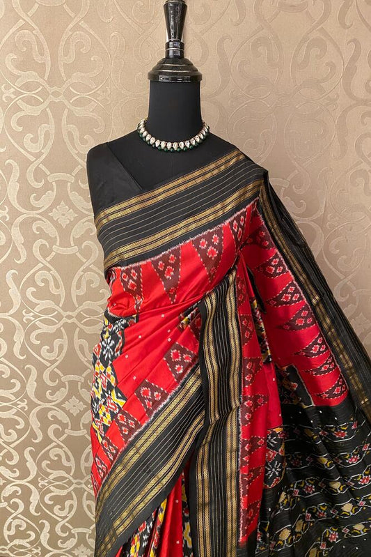 Cherry red Pochampally Ikat silk saree with intricate traditional patterns and an unstiched blouse, crafted by Saarang Sarees.