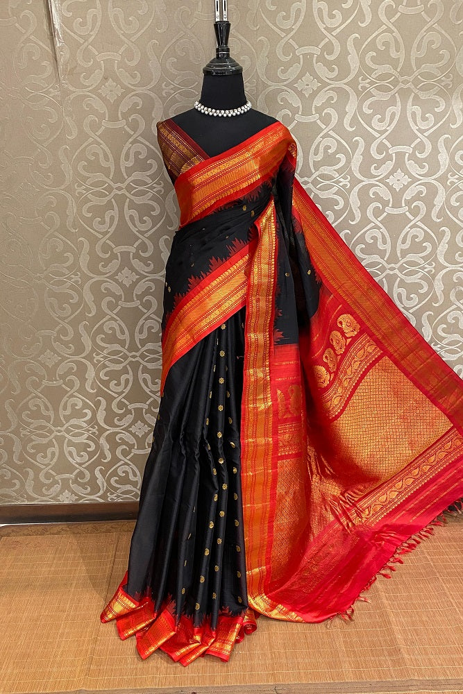 Black Sico Gadwal saree with intricate gold border and matching unstiched blouse, traditional wear by Saarang Sarees.
