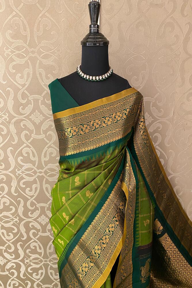 Green Gadwal Silk Saree with traditional design and unstitched blouse from Saarang Sarees, showcasing intricate silk fabric and craftsmanship.