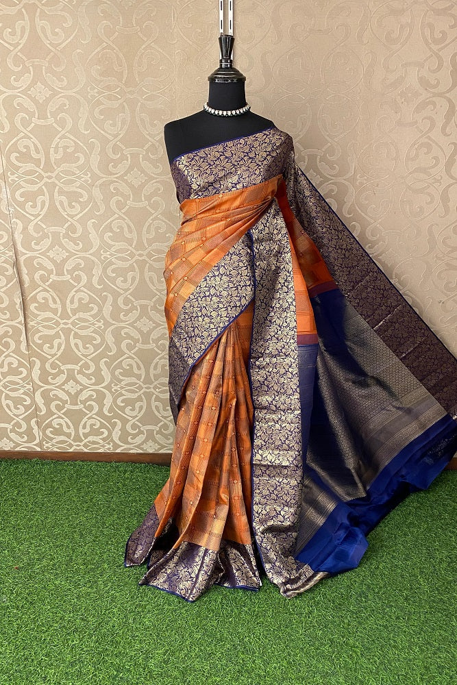 Orange pure Kanjeevaram silk saree with traditional gold border and matching unstiched blouse, showcasing intricate craftsmanship.