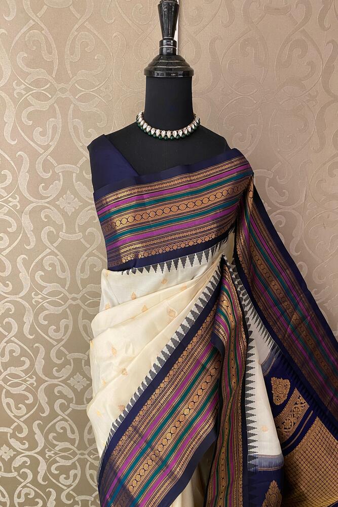 Off-White Gadwal silk saree with intricate traditional patterns, paired with an unstiched blouse, from Saarang Sarees.