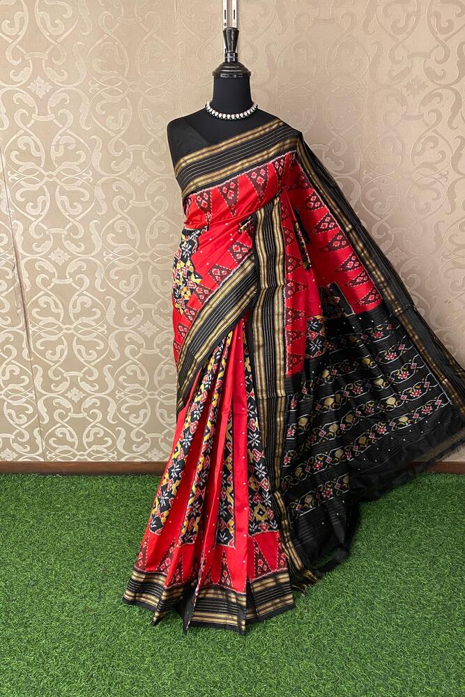 Cherry red Pochampally Ikat silk saree with traditional design and matching unstiched blouse, by Saarang Sarees.