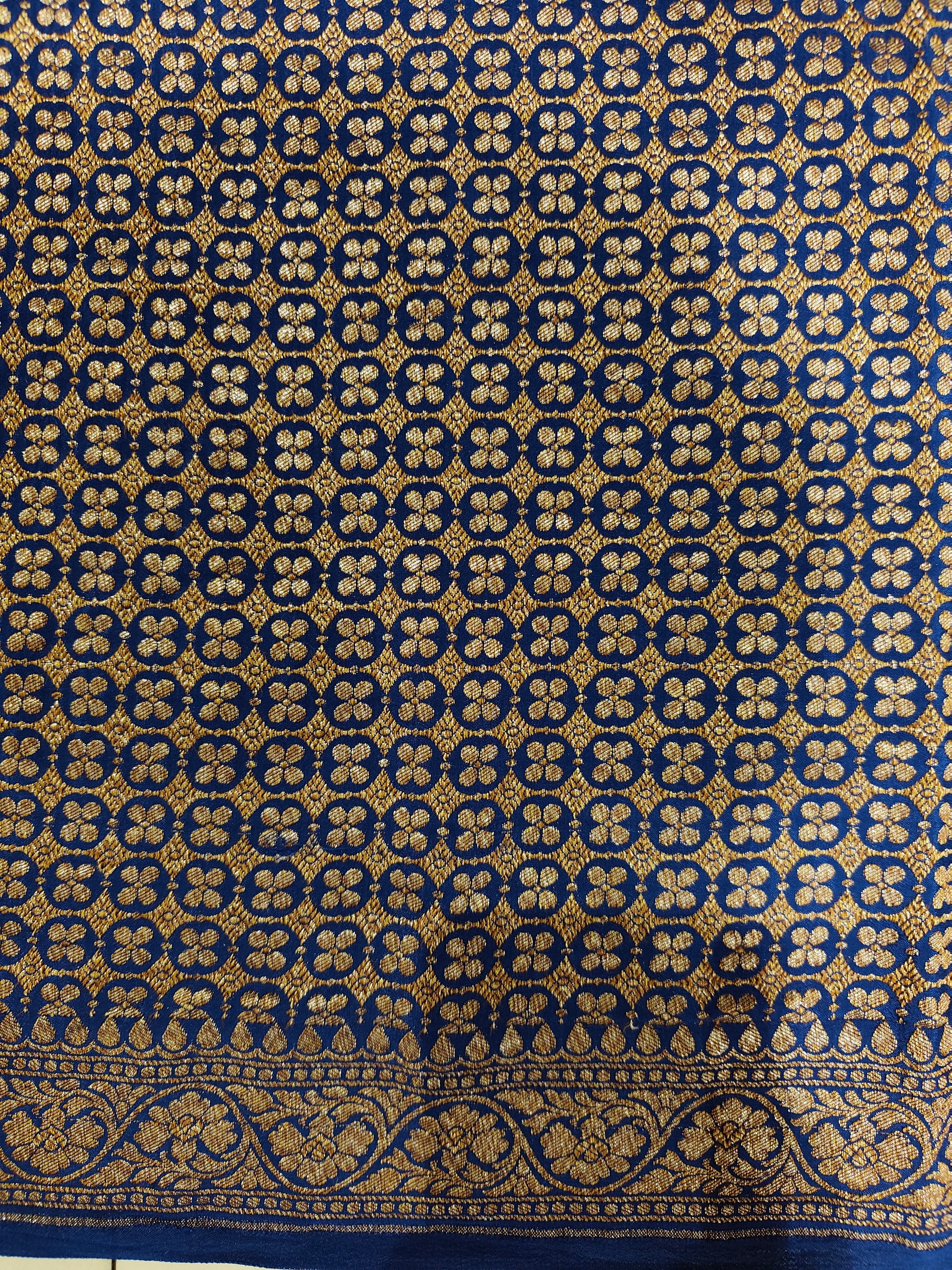 Blue crepe Khaddi Banarasi silk saree with intricate gold patterns and matching unstiched blouse, traditional wear by Saarang Sarees.