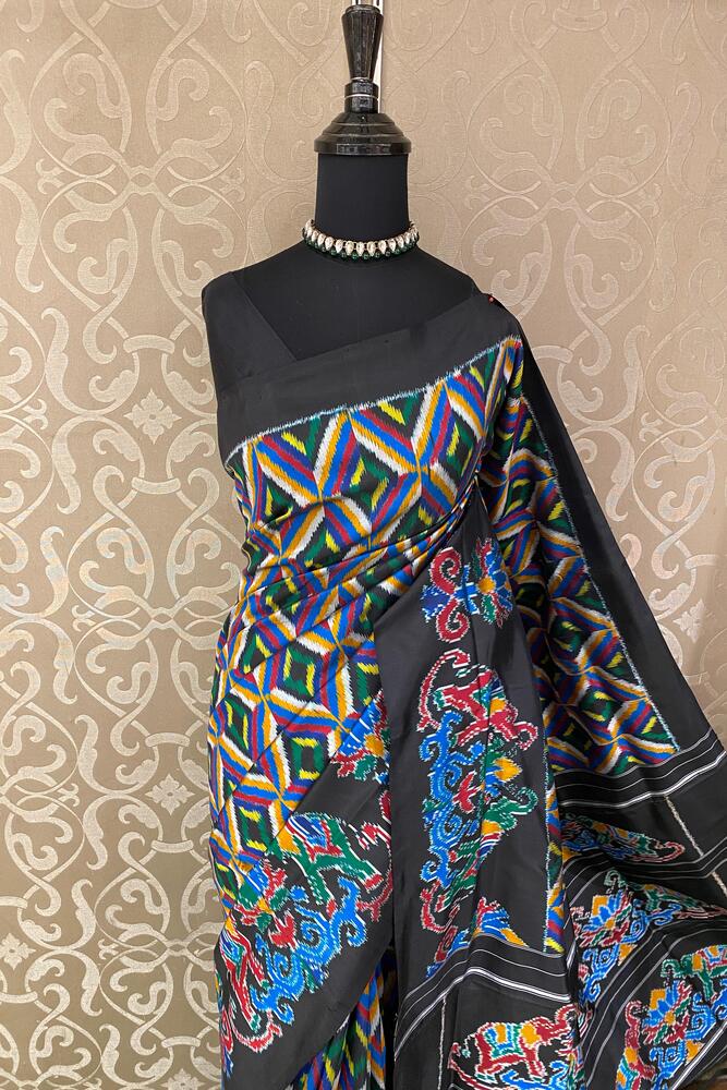 Black Pochampally Ikat silk saree with multi-color weaving and unstitched blouse, traditional wear from Saarang Sarees.