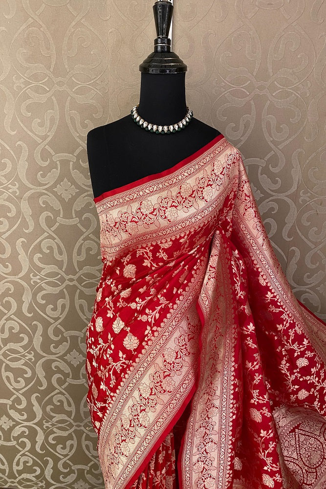 Red Uppada Banarasi saree with intricate gold zari work and matching unstiched blouse, traditional wear by Saarang Sarees.