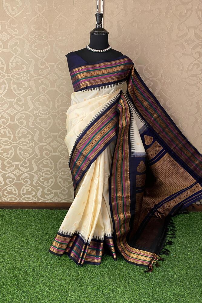 Off-White Gadwal Silk Saree with traditional design and intricate patterns, paired with an unstiched blouse from Saarang Sarees.