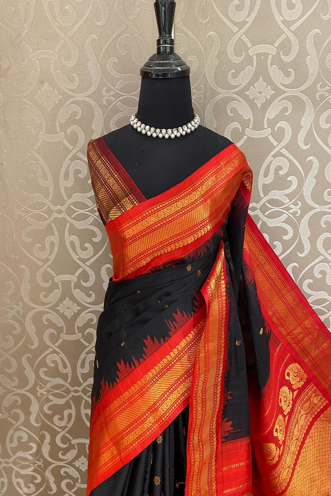 Black Sico Gadwal saree with intricate gold accents and an unstiched blouse, traditional wear by Saarang Sarees.