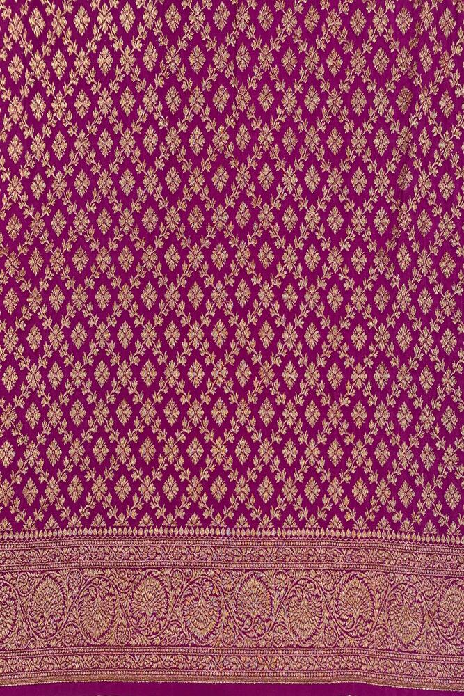 Magenta Mysore Crepe Silk Banarasi saree with intricate gold zari work and an unstiched blouse, traditional wear from Saarang Sarees.