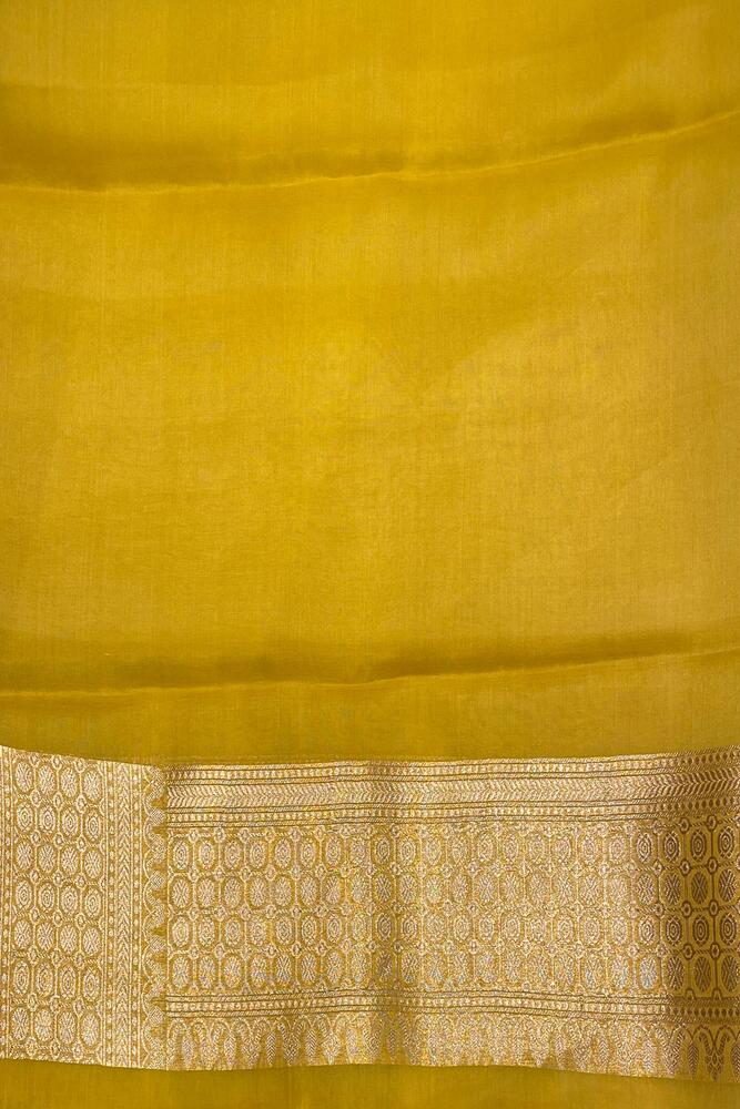 Mustard yellow Kora Banarasi silk saree with intricate hand weaving work and matching unstiched blouse for traditional wear.