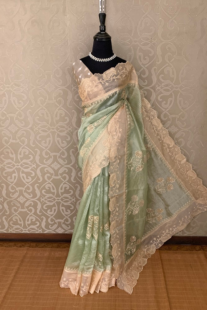 Pista green pure organza saree with intricate applique work, featuring elegant drape and detailed embellishments from Saarang Sarees.