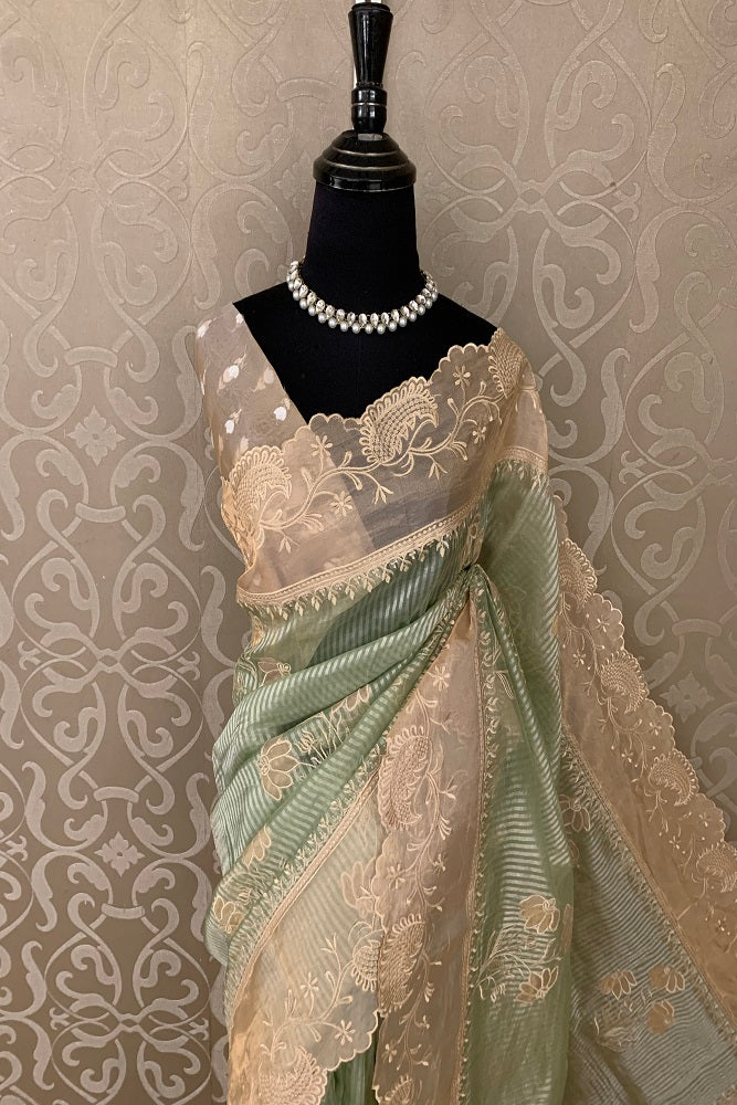 Pista green pure organza saree with intricate applique work from Saarang Sarees, showcasing elegant drape and detailed embroidery.
