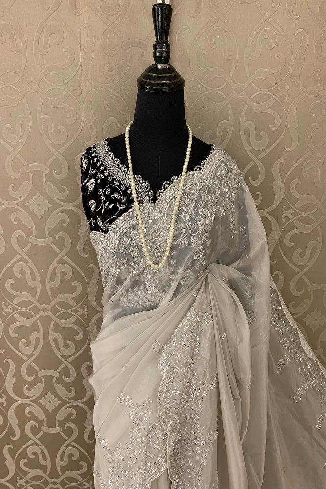 CREAM TISSUE ORGANZA SAREE WITH SEQUINS EMBRIODERY AND READYMADE BLUE BLOUSE